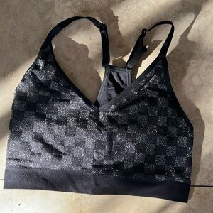 Pink black sports bra with silver checkered print. Size Large.